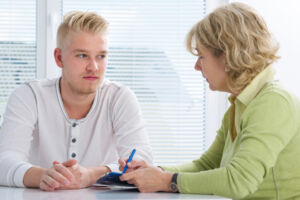 understanding addiction treatment insurance consultation between man and women